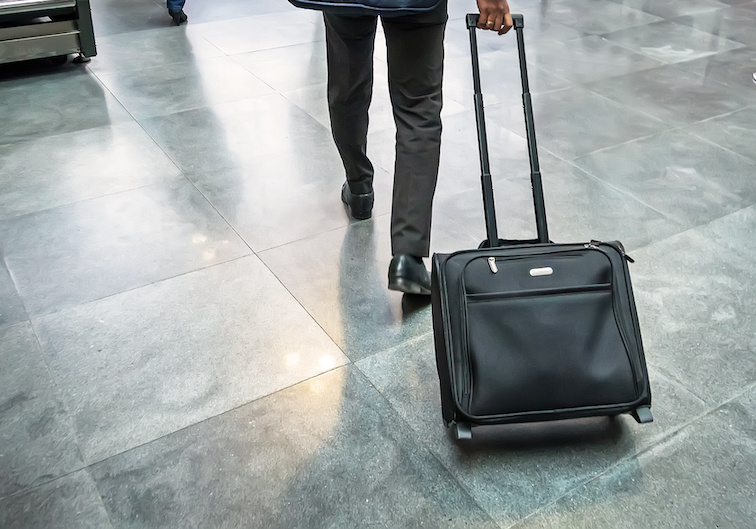 bigstock-Man-Traveller-With-Travel-Suit-233606932-1